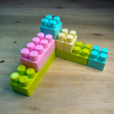 Plastic building blocks on wooden background. Top view. Copy space.の写真素材
