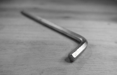 Metal spanner on a wooden background. Black and white photo.の写真素材