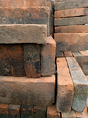 Stack of bricks in construction site. Red brick background. Close-up.