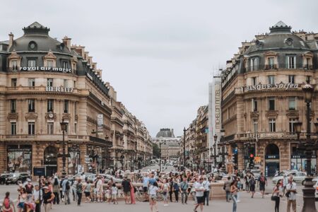 PARIS, FRANCE - JULY 19th, 2014. A view down Avenue de l'Opera busy with pedestrians and traffic on a summer day with high clouds. Cloudy weatherのeditorial素材