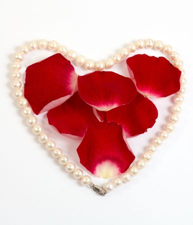 Pearl heart and red rose petals                               の写真素材
