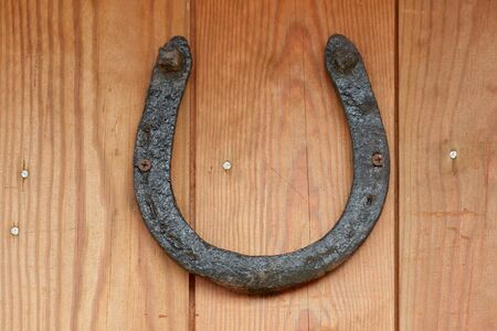 Old lucky horseshoe on wooden new wall                                の写真素材