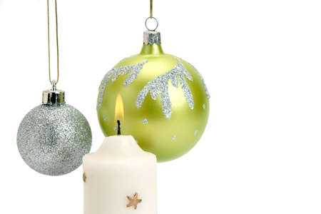 Christmas Baubles and Candle on a white backgroundの写真素材