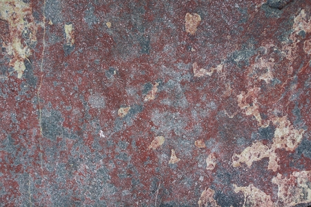 Surface of natural  dark red stone  crimson quartzite porphyry  as backgroundの写真素材