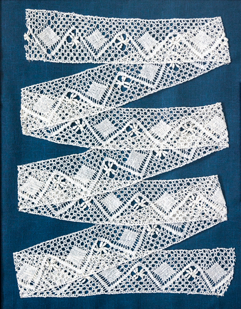 Vintage White Lace Ribbon on blue backgroundの写真素材