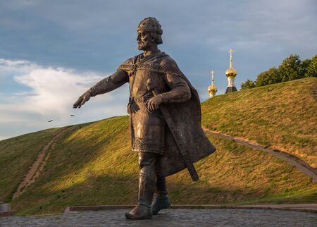 Bronze monument to Yuri Dolgoruky on earthen ramparts background of ancient Kremlin, Dmitrov, Moscow...