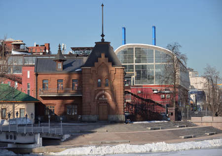 Moscow, Russia, March 11, 2021: View of Buildings of confectionery factory "Red October" on Bolotnaya embankment and Drainage (Vodootvodny) Canal during ice drift in early spring on sunny dayのeditorial素材