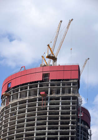 Construction of high-rise building with Tower cranes on clear sunny dayの写真素材
