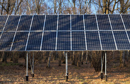 Solar panels in autumn park on sunny day