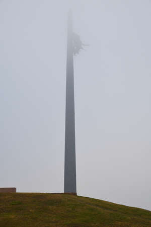 Main obelisk 141.8 meters high in form of soldier's bayonet with bronze goddess of victory Nika, Poklonnaya Hill in heavy fog, Moscow, Russiaの写真素材