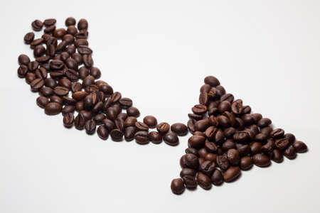 Coffee beans in the form of arrow isolated on white background. Arrow of coffee beansの写真素材