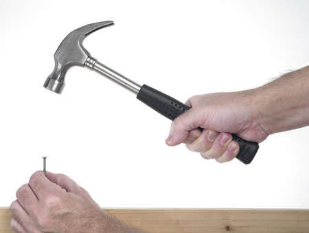 hand of man that hold hammer on the white background while poundingの写真素材