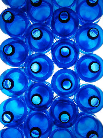pile of blue plastic bottles on white backgroundの写真素材