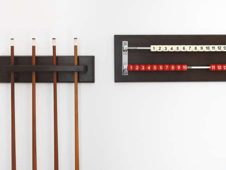 billiard cue and rack with numbers on white wallの写真素材