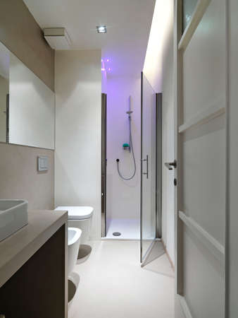 interior view of a modern bathroom in foreground shower cubicleの写真素材