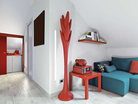 interior view of a modern living room with fabric sofa, red  hantstand overlooking on the kitchen in the attic roomの写真素材