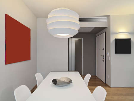 foreground of modern white dining trable with chandelierの写真素材