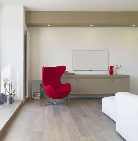 interior view of a modern living room with red armchair and wood floorの写真素材
