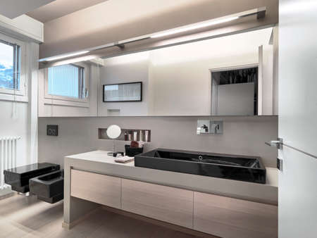 interior view of a modern bathroom in foreground the washbasinの写真素材