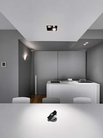 interior view of a modern kitchen in foreground the telephone on the tableの写真素材
