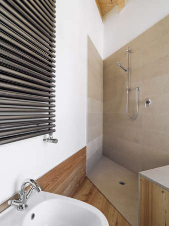 interior view of a modern bathroom in foreground the masonry shower cubicle coated of marbleの写真素材