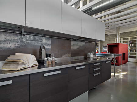 interiors shots of a modern kitchen overlooking on the living roomの写真素材