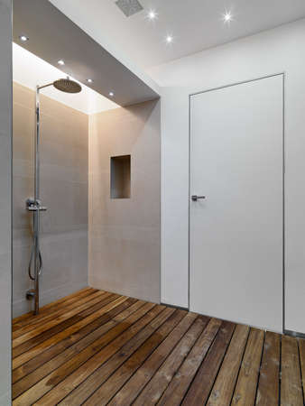 interior view of a shower cubicle in the modern bathroom with wood floorの写真素材