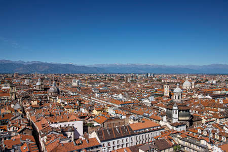 landscape on the roofs of Turin by Piedmont in Italy in the background the mountainsの写真素材