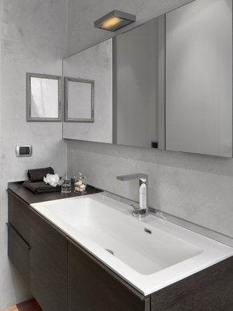 interior view of a modern bathroom with a close-up of the washbasin integrated into the cabinetの写真素材