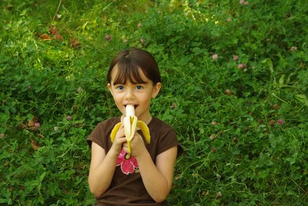 Girl eating a bananaの写真素材