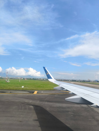 Air Astana Aircraft Wing View Over Varied Landscapes and Cloudsのeditorial素材