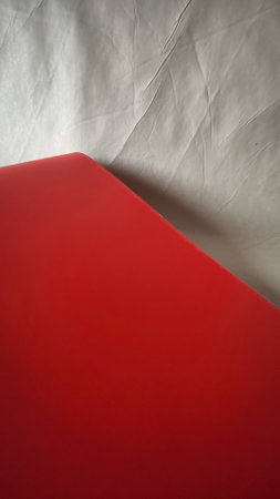 Red book on a white sheet of paper, close-up.の写真素材