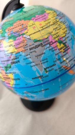 Globe with map of the world on a white tablecloth.