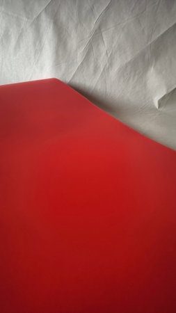 Red and white sheets of paper as a background. Horizontal frame