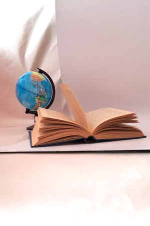 globe and open book on white background, education and learning conceptの写真素材