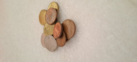 Coins on the wall of the house. Concept of saving money.