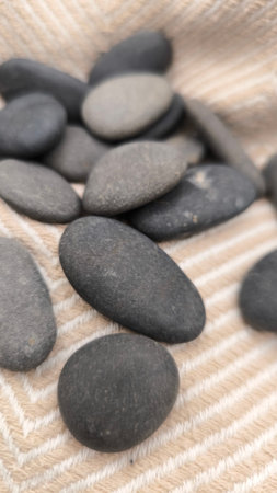 Spa stones on a background of brown fabric. Shallow depth of field