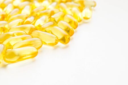 Fish oil fat capsules with omega 3 and vitamin D on white background, healthy diet conceptの写真素材