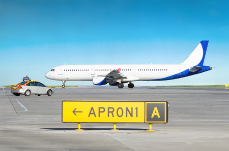 Aircraft at the airport after landing and the airport service car with the inscription follow me.の写真素材