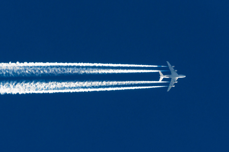 Airplane big four engines aviation airport contrail clouds.の写真素材