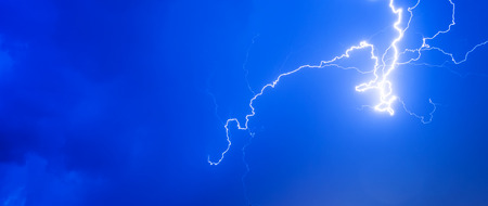 Thunderstorms thunder lightning night sky clouds overcast summer rain, background panorama and with space for text.の写真素材