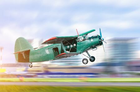 Climbing take off old retro turbo jet on a city background.