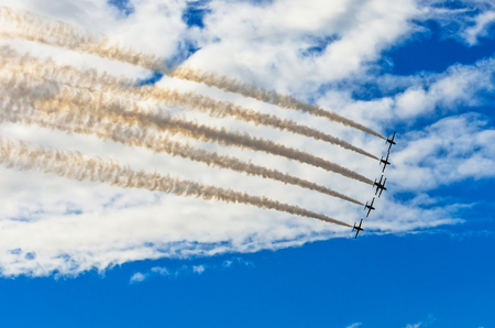 Aircraft fighter jets smoke the background of blue sky white clouds.の写真素材