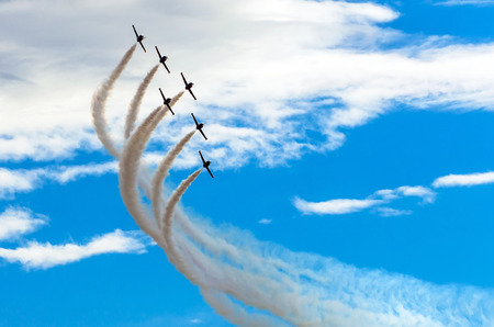 Aircraft fighter jets smoke the background of blue sky white clouds.