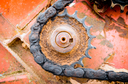 Old rusty gear and oil chain nearの写真素材