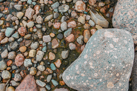 Stones large and small on the shore of the bayの写真素材