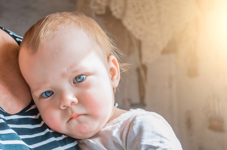 Thoughtful glance of the child pressed to his grandmother's breast