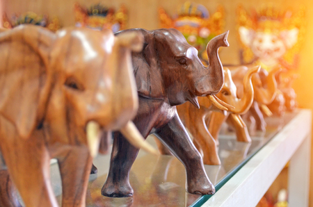 Wooden elephant figurines lined up in a rowの写真素材