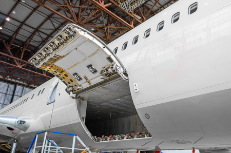 Luggage compartment and cargo section in the airplane open on inspectionの写真素材