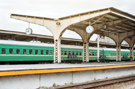 Passenger cars at the old station with a clock. Konpet trains by train, waiting, meeting and seeing off for a tripの写真素材